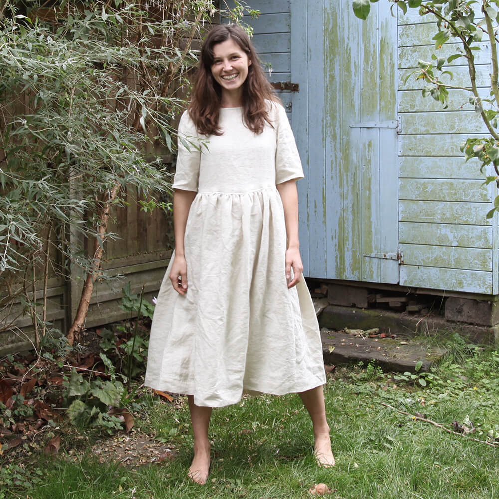 Woman wearing cream gathered skirt dress
