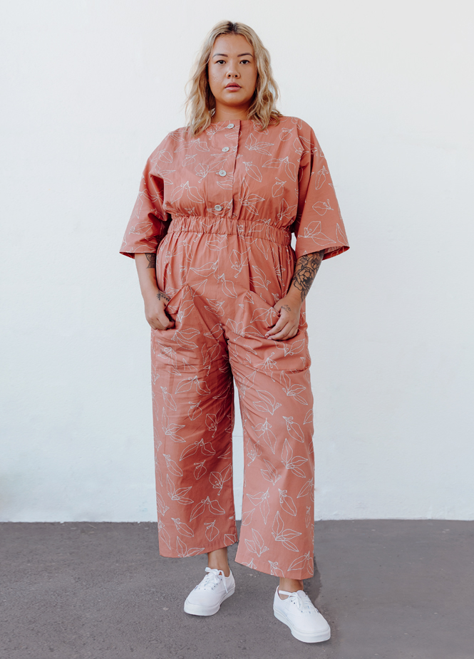 Woman wearing coral button-up jumpsuit